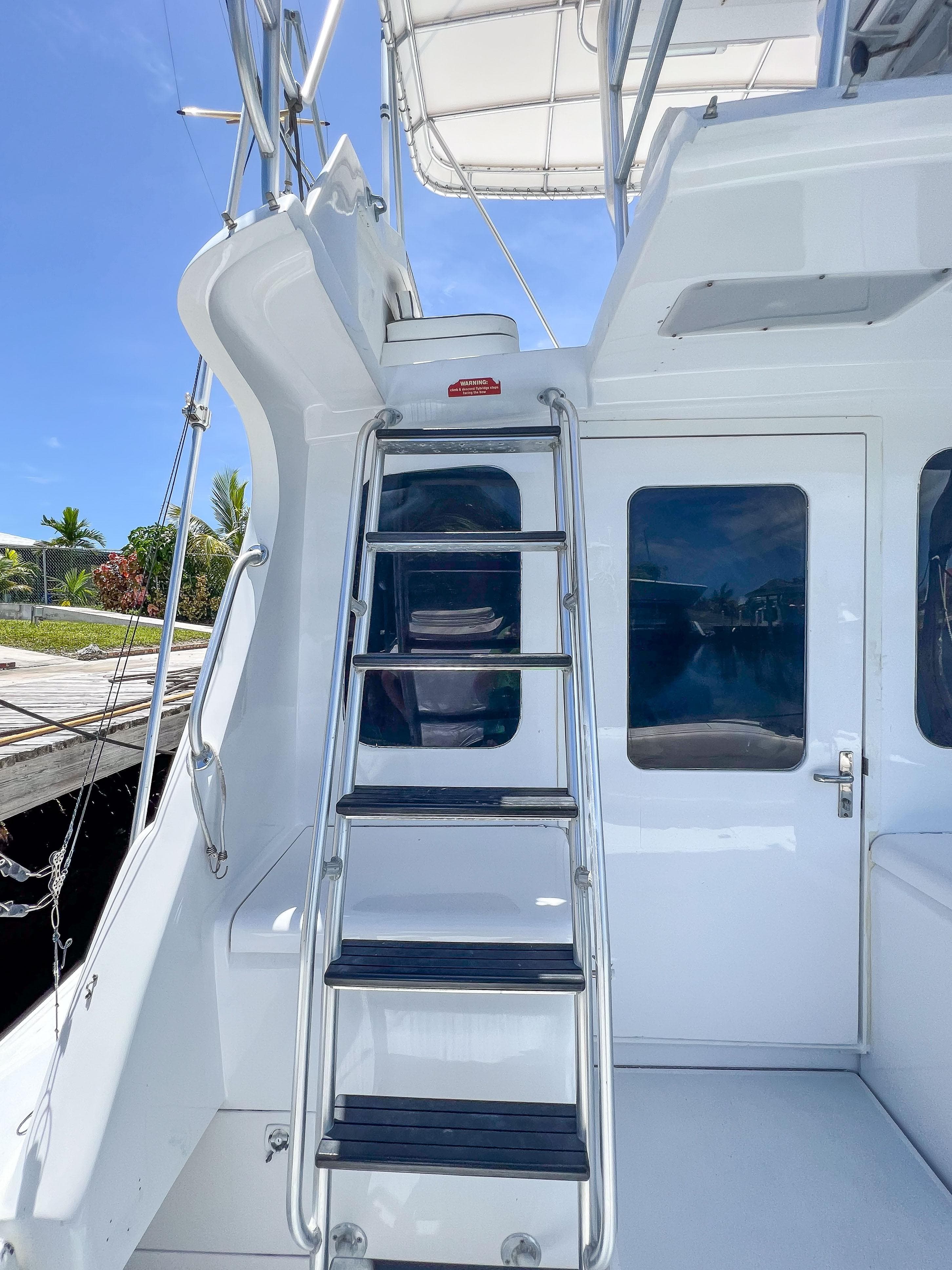 Stainless steel ladder on a 2000 Luhrs 400 Convertible yacht, leading to the flybridge.