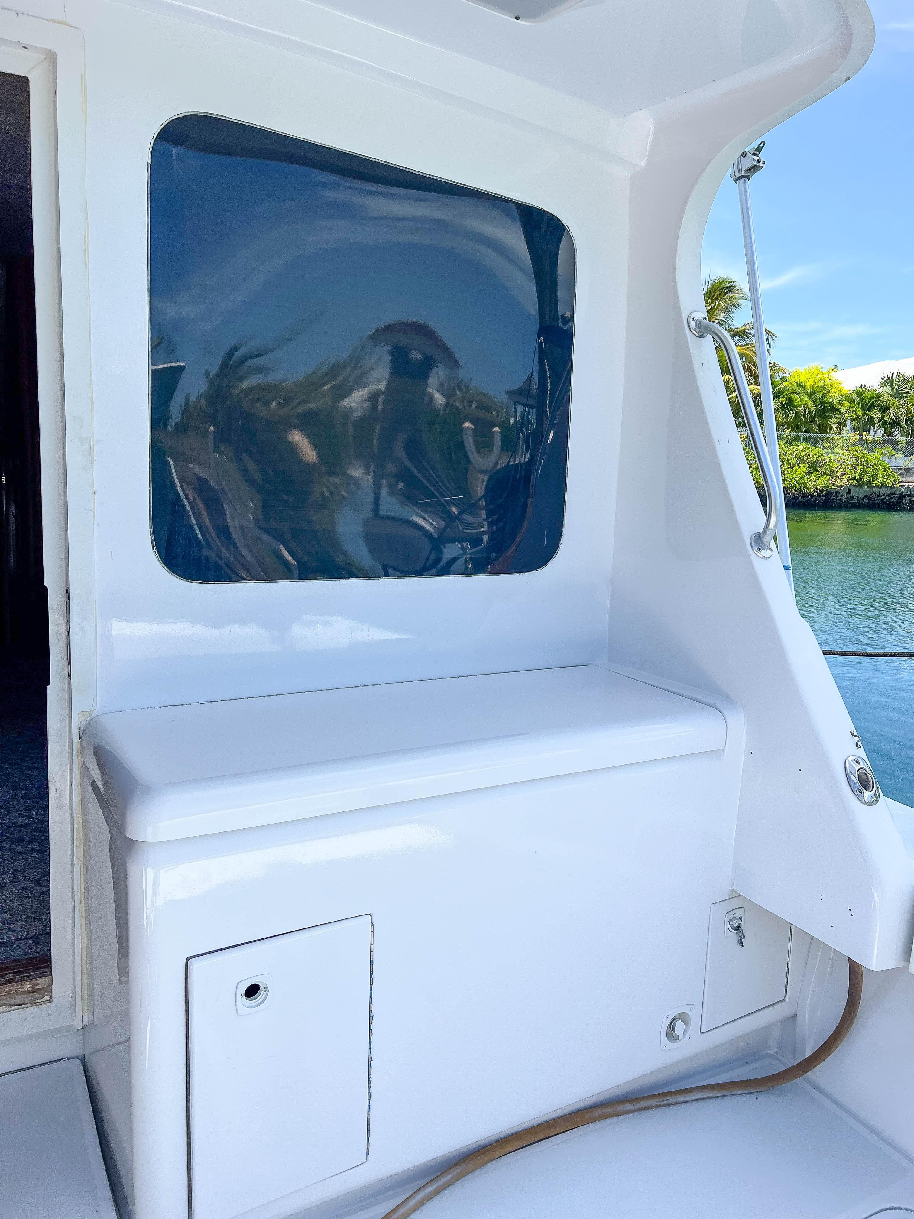 2000 Luhrs 400 Convertible boat interior with window and storage compartment.