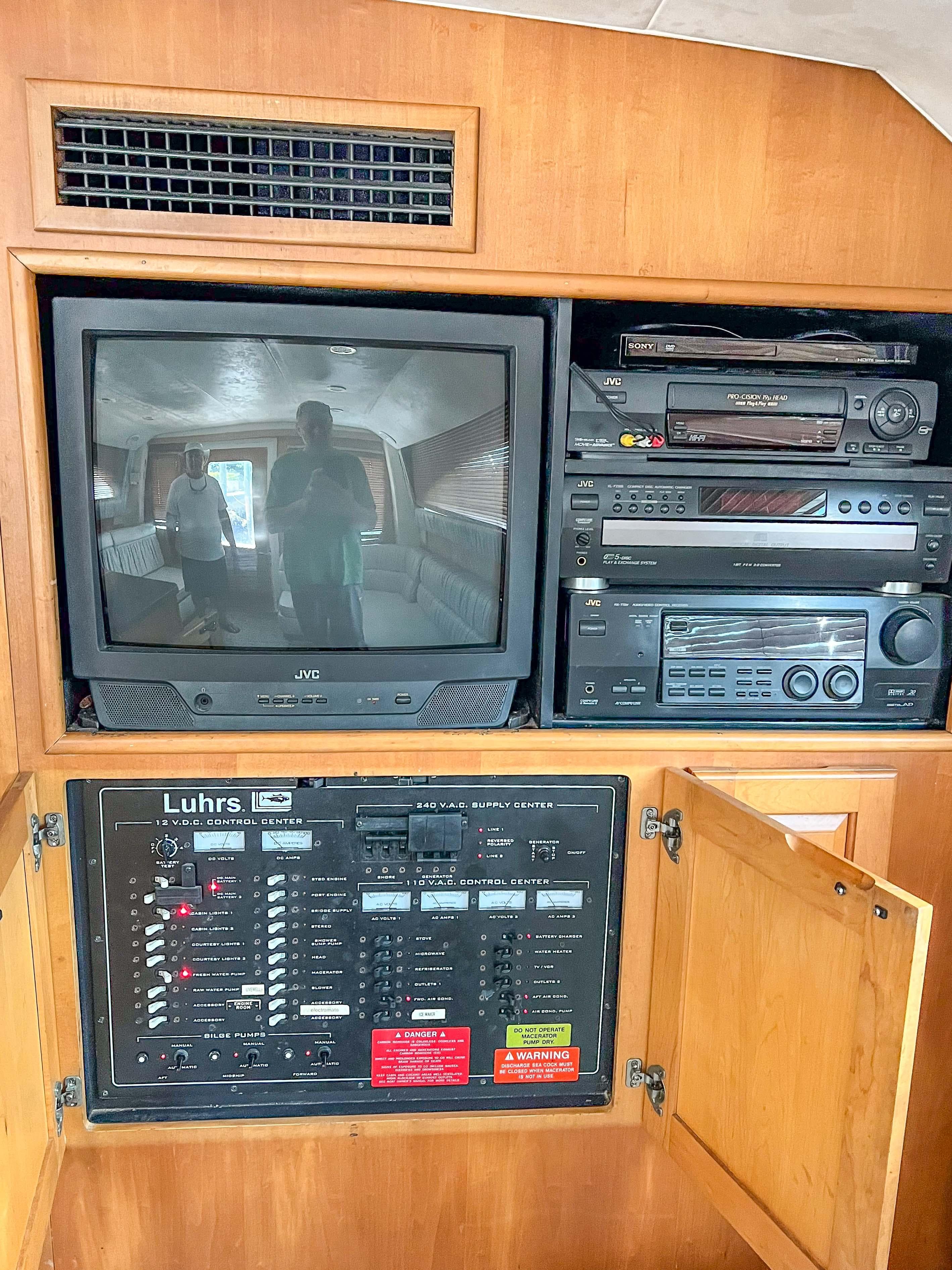 2000 Luhrs 400 Convertible entertainment system with TV and control panel.