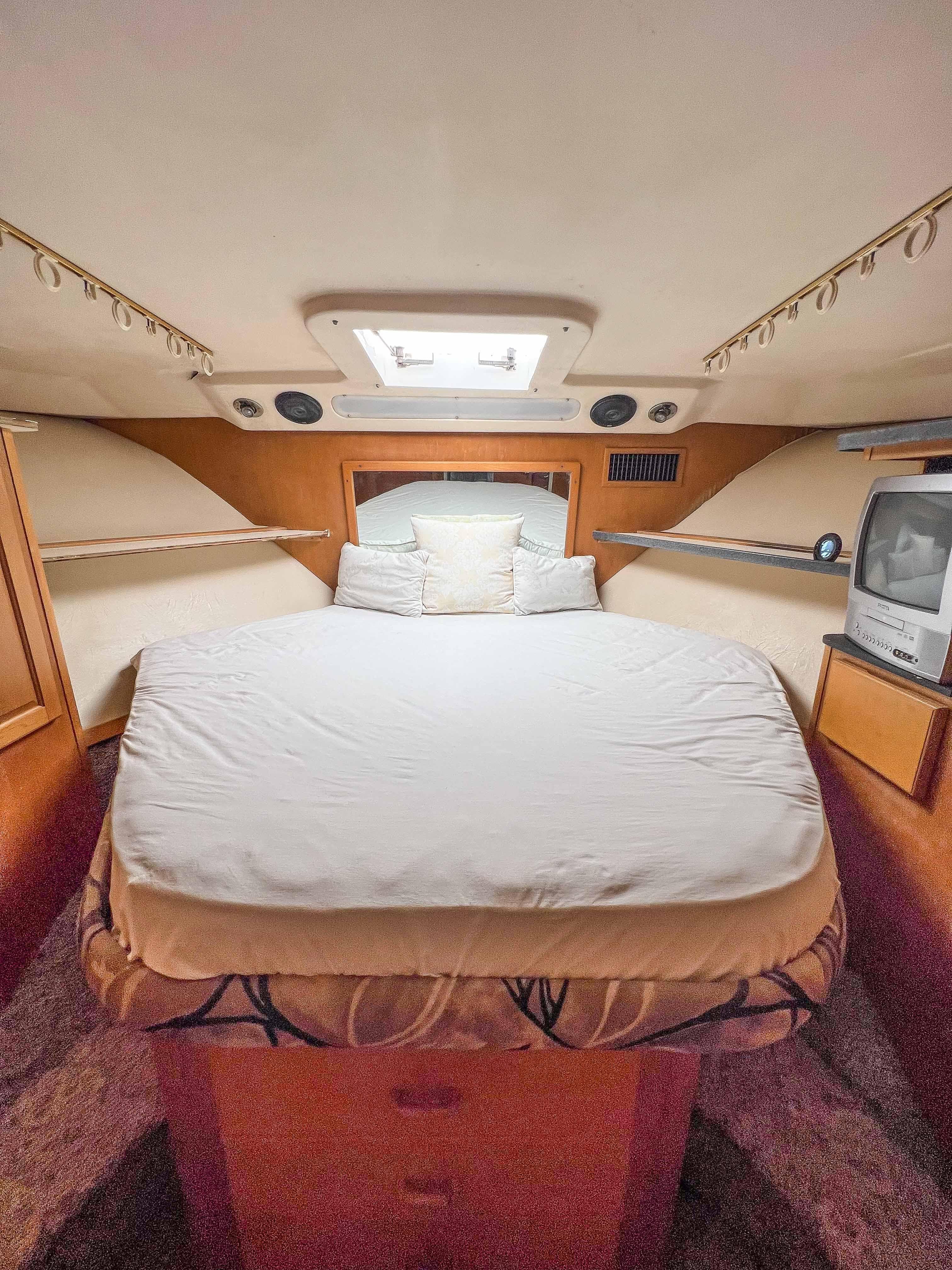 2000 Luhrs 400 Convertible boat cabin with bed and TV.