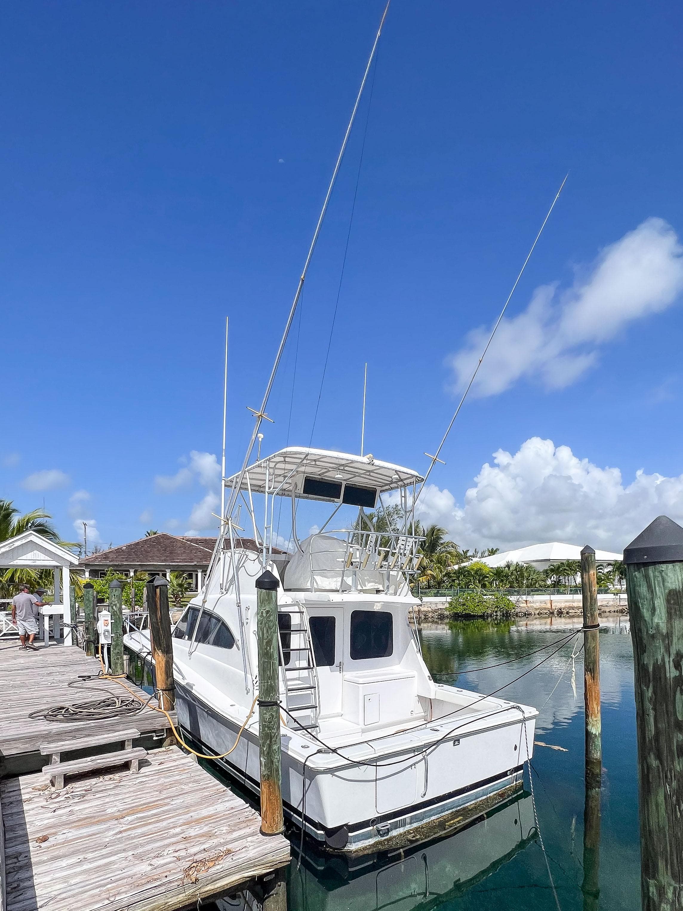 2000 Luhrs 400 Convertible boat docked at a marina on a sunny day.